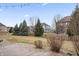 Spacious backyard featuring well-manicured lawn, mature trees, and a view of neighboring homes at 10264 Normandy Way, Fishers, IN 46040