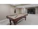 Finished basement featuring a pool table and a stylish dark wood entertainment center at 10264 Normandy Way, Fishers, IN 46040