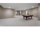 Spacious finished basement featuring a pool table with carpet flooring and neutral colored walls at 10264 Normandy Way, Fishers, IN 46040