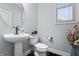 Powder room featuring modern fixtures, pedestal sink, and updated lighting at 10264 Normandy Way, Fishers, IN 46040