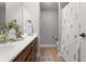 Bathroom features a double wood vanity, neutral walls, and a decorative shower curtain at 10264 Normandy Way, Fishers, IN 46040
