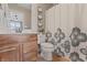 Bathroom features a wood vanity, neutral walls, and a decorative shower curtain at 10264 Normandy Way, Fishers, IN 46040