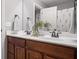 Bathroom features a double wood vanity, neutral walls, and decorative mirrors at 10264 Normandy Way, Fishers, IN 46040