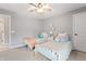 Charming bedroom featuring twin beds with decorative pillows and stylish ceiling fan at 10264 Normandy Way, Fishers, IN 46040