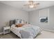 Bedroom features stylish decor, a ceiling fan, neutral walls, and a comfortable upholstered bed at 10264 Normandy Way, Fishers, IN 46040