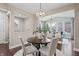 Cozy dining area features hardwood floors, an elegant chandelier, and views into the living room at 10264 Normandy Way, Fishers, IN 46040