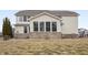 Exterior view of home featuring a sunroom with many windows and large yard at 10264 Normandy Way, Fishers, IN 46040