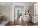 Elegant foyer with hardwood floors, modern console table and decorative wall art at 10264 Normandy Way, Fishers, IN 46040