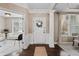 Bright foyer with hardwood flooring, white trim and a view to the living room at 10264 Normandy Way, Fishers, IN 46040