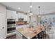 Gourmet kitchen features a granite island, modern appliances, and pendant lighting at 10264 Normandy Way, Fishers, IN 46040