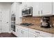 Modern kitchen features a gas cooktop, built in oven, and stainless steel appliances at 10264 Normandy Way, Fishers, IN 46040