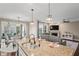 Open kitchen with granite countertops, stainless steel appliances, and seamless flow into the living and dining areas at 10264 Normandy Way, Fishers, IN 46040