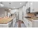 Spacious kitchen boasts white cabinetry, stainless appliances, and granite countertops at 10264 Normandy Way, Fishers, IN 46040