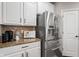 Updated kitchen with stainless steel fridge, granite counters, and modern appliances at 10264 Normandy Way, Fishers, IN 46040