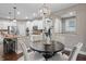 Open layout showcasing kitchen with modern appliances connected to dining area with stylish chandelier at 10264 Normandy Way, Fishers, IN 46040