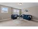 Inviting living room featuring plush blue sofas, a stylish rug, and ample natural light from the large windows at 10264 Normandy Way, Fishers, IN 46040