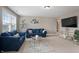 Comfortable living room with blue sofas, a modern coffee table, and a decorative wall arrangement at 10264 Normandy Way, Fishers, IN 46040