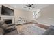 Relaxing living room with a cozy fireplace, TV, staircase and plush seating at 10264 Normandy Way, Fishers, IN 46040