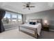 Serene primary bedroom featuring a large bed, ceiling fan, and windows for ample natural light at 10264 Normandy Way, Fishers, IN 46040