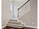 Carpeted staircase with wood railings and decorative iron spindles at 10264 Normandy Way, Fishers, IN 46040