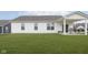 Well-maintained backyard with a lush lawn and covered patio area, great for entertaining at 1030 Macoun Dr, Westfield, IN 46074