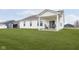 Expansive backyard features a covered patio with outdoor seating and well-manicured lawn at 1030 Macoun Dr, Westfield, IN 46074