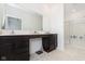 Spacious bathroom with dual sink vanity, dark cabinets, and a walk-in shower with glass door at 1030 Macoun Dr, Westfield, IN 46074