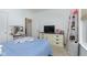 Bedroom featuring a closet, window, dresser, and a bed with blue bedding at 1030 Macoun Dr, Westfield, IN 46074