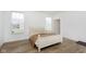 Bright bedroom featuring wood floors, a large window, and a comfortable bed at 1030 Macoun Dr, Westfield, IN 46074
