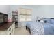 Bedroom featuring a bed with blue bedding, window, dresser, and shelving at 1030 Macoun Dr, Westfield, IN 46074