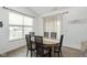 Bright dining area features a wood table, six chairs, and natural light from a large window at 1030 Macoun Dr, Westfield, IN 46074
