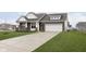 Attractive home with a brick and siding exterior, lush lawn, and spacious driveway at 1030 Macoun Dr, Westfield, IN 46074