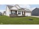 Inviting home featuring a well-kept lawn, brick accents, and a two-car garage at 1030 Macoun Dr, Westfield, IN 46074
