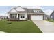 Charming two-story home with a brick and siding exterior and a well-manicured lawn at 1030 Macoun Dr, Westfield, IN 46074