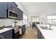 Modern kitchen features stainless appliances, solid countertops, and open layout to dining area at 1030 Macoun Dr, Westfield, IN 46074