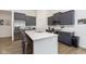Modern kitchen with gray cabinets, stainless steel appliances, and a large island at 1030 Macoun Dr, Westfield, IN 46074