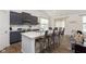Stylish kitchen features an island with seating, modern appliances, and dark gray cabinetry at 1030 Macoun Dr, Westfield, IN 46074