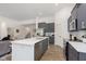 Stylish kitchen featuring gray cabinets, stainless appliances, and open access to the living area at 1030 Macoun Dr, Westfield, IN 46074