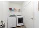 Convenient laundry room featuring modern washer and dryer units, plus handy shelving at 1030 Macoun Dr, Westfield, IN 46074