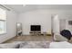 Bright living room featuring a comfortable armchair, entertainment center, and natural light at 1030 Macoun Dr, Westfield, IN 46074