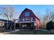 Exterior view of Nyla's restaurant with a red barn exterior and outdoor seating at 1030 Macoun Dr, Westfield, IN 46074