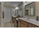 Well-lit bathroom with dual sinks, large mirrors, and stylish vanity seating at 10329 Gateway Dr, Indianapolis, IN 46234