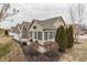 Home's exterior view featuring well-maintained landscaping, tan siding and multiple large windows at 10329 Gateway Dr, Indianapolis, IN 46234