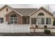 A single Gathering home showcases a mixture of brick and vinyl siding and a white picket fence at 10329 Gateway Dr, Indianapolis, IN 46234