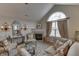 Cozy living room with a fireplace, large window, and elegant furnishings at 10329 Gateway Dr, Indianapolis, IN 46234