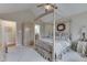 Relaxing bedroom showcasing a canopy bed, plush carpeting, and ample natural light at 10329 Gateway Dr, Indianapolis, IN 46234