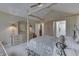Spacious bedroom features a canopy bed, neutral walls, and adjacent bathroom access at 10329 Gateway Dr, Indianapolis, IN 46234
