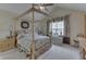 Comfortable bedroom featuring a four-poster bed, carpet, and neutral decor at 10329 Gateway Dr, Indianapolis, IN 46234