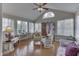 Bright sunroom filled with natural light, featuring hardwood floors and comfortable seating at 10329 Gateway Dr, Indianapolis, IN 46234