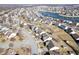 Residential area aerial view with tree-lined streets, houses, and partially frozen pond at 10373 Cerulean Dr, Noblesville, IN 46060